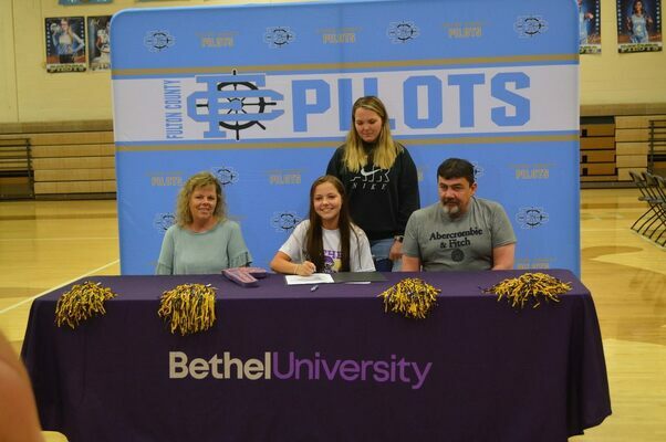 ESPORTS LETTER OF INTENT - Carly Worley, center, had her family Tim and Tonya Totty and sister, with her as she signed her Letter of Intent on May 6, to attend Bethel University on an Esports scholarship. The entire Fulton County High School student body turned out to watch the ceremony. (Photo by Barbara Atwill)