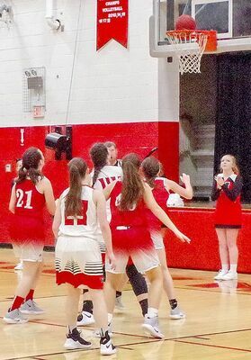 BATTLE OF BOARDS – Lady Falcons and Livingston County players battle for a rebound in their Dec. 1 contest. (Photo by Becky Meadows)