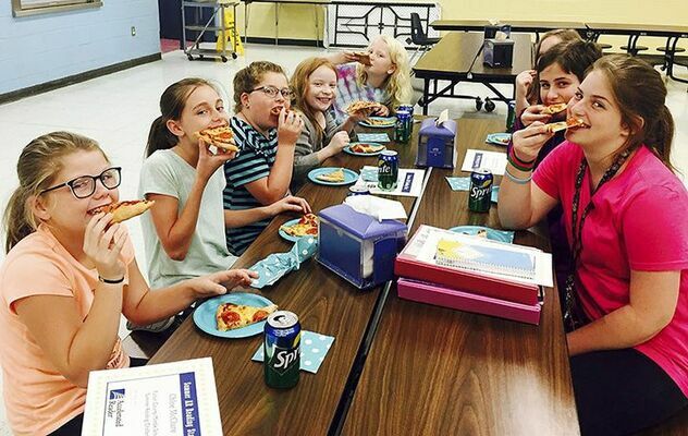 PIZZA REWARDS - Students enjoying a pizza party for accepting the Captain’s Reading Challenge over the summer and reading multiple books included, clockwise from left, Chloe McClure, McKayden McClure, Emmarie Cermak, Alexis Edgin, Miriam Varden, Zoie Somerfield, Lily Hershberger, and Kally Hershberger. (Photo submitted)