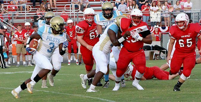 BIG RUN – Pilots tailback Caleb Kimble (3) runs around end during the first quarter of their game at South Fulton. Kimble scored three touchdowns in the first quarter, but was sidelined in the second quarter due to a mild concussion. The Red Devils scored 24 unanswered points in the second half to beat Fulton County 36-30 in double overtime. (Photo by Charles Choate)