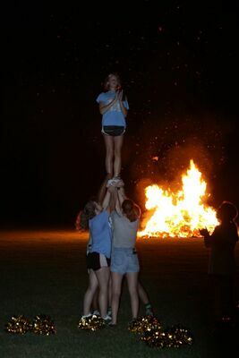 HISTORY REPEATS - Fulton County High School brought back the tradition of a parade and bonfire the night before their Homecoming game. Cheerleaders pumped up the crowd with their builds and cheers with the bonfire in the background on Oct. 14. (Photo by Barbara Atwill)