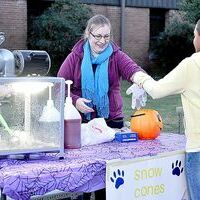 FROZEN FALL FEST FUN -- Amity Grinstead, Music Teacher for Fulton Independent Schools, serves up a frosty refreshment during the annual Fall Festival held on the campus of Fulton Independent Middle and High Schools Saturday evening. A large crowd of students and families were in attendance for the annual fundraiser, as games and activities were displayed on the grounds, as well as inside the school. Teachers and staff volunteered to oversee the various events, which included ring toss, a car bash, giant inflatables, cake walk and silent auction. Proceeds benefit the school. (Photo by Benita Fuzzell.)