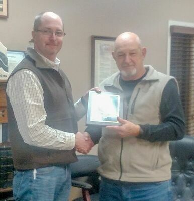 Superintendent Casey Henderson presenting Allen Kyle a plaque to recognize 27 ½ years on the Hickman County Board of Education.  (Photo by Becky Meadows)