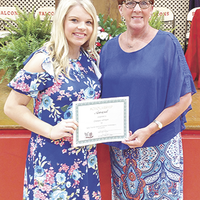 Chelsea Johnson, left, was the recipient of the Bette Chandler Memorial Extension Homemaker’s Scholarship at the recent Hickman County High School Honors Night. Sara Stroud, right, presented her with the certificate. (Photo submitted)