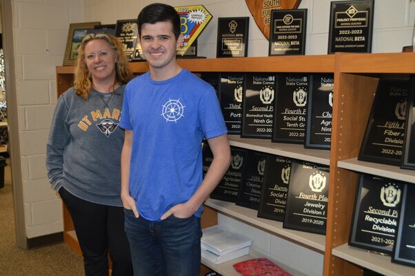 South Fulton High School Senior Daniel Pitts is pictured with his Beta Club sponsor, Brandi Cantrell, in front of one wall of Beta Club awards displayed in the SFHS Library. Numerous other awards earned by Beta Club members through the years also are exhibited in other locations throughout the Library, earned at state and national levels of competition. (Photos by Benita Fuzzell)