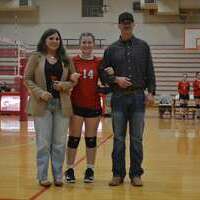 VOLLEYBALL EIGHTH GRADE NIGHT –  South Fulton Middle School's Lady Red Devils Volleyball Team member, #14, Carlisle Lusk, an eighth grader, was honored along with her parents, Daniel and Allie Lusk, March 5, at the SFMS home match, for Eighth Grade Night ceremonies. (Photo by Benita Fuzzell.)
