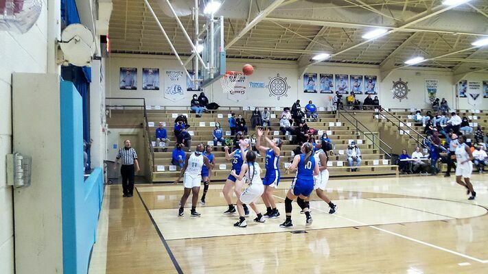 All eyes are on the ball as both Lady Pilots and Blue Tornadoes wait to see if the shot is good or not. (Photo by Mark Collier)