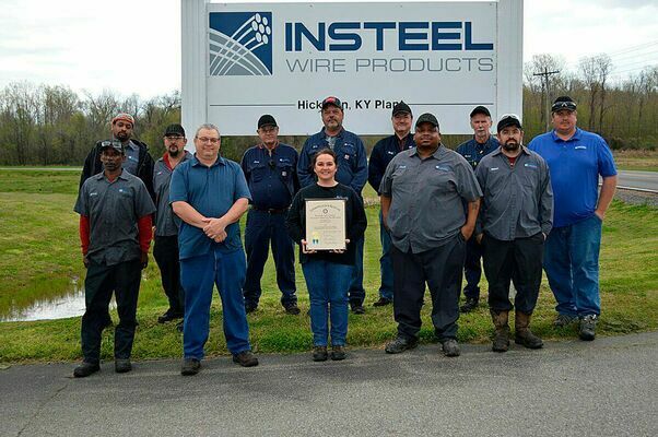 SAFETY AWARD – Insteel Wire Products of Hickman received the Governor's Safety and Health Award for achieving 250,000 hours of work without an injury. Members of Insteel of Hickman are shown in front of the company sign and the plaque received. (Photo by Barbara Atwill)