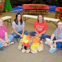 South Fulton Elementary teachers Laura Murphy, Christa Hankins, Amanda Wilder and Penny Burton gather around the “campfire” created in the SFES library for the Read To Be Ready Summer grant funded reading program, “Camp Reel”, running through June. (Photo by Benita Fuzzell.)