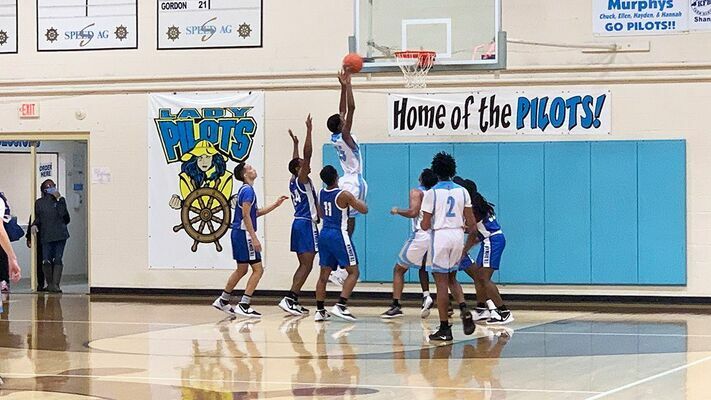 Fulton County High School Pilot Omarion Pierce soars high to pull down one of his four rebounds when the Pilots hosted the Paducah Tilghman Blue Tornadoes Jan. 15. (Photo by Mark Collier)