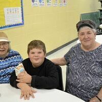 TREATING GRANDPARENTS – Fulton County Elementary School and Fulton County Middle School treated grandparents to a luncheon on Sept. 7 in the school’s cafeteria for ages K-8. Peggy O’Connor, left, enjoyed lunch with her great-grandson, Kael O’Connor. Phyllis Simmons, eight, also joined the fun. (Photo by Barbara Atwill)