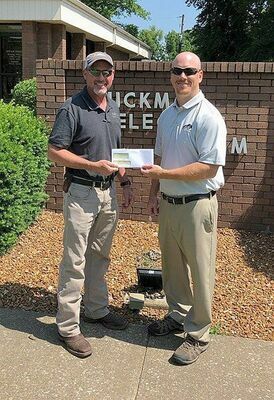 GRANT RECEIVED FOR SAFETY – Hickman Electric System Manager Rex Coffey, left, receives a check from Ben Cook, Kentucky League of Cities Insurance Services (KLCIS) Loss Control Specialist. Hickman Electric System received a $1,500 grant from the KLCIS. The grant will be used for personal protective equipment, KLCIS Risk and Safety Conference, ice and snow traction devices, and safety training and Utilities safety manuals. (Photo submitted)
