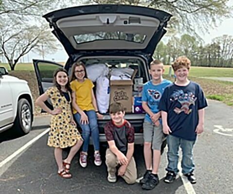 Pictured are some of the SFE Beta members loading the items in Johnnie Cloar’s car to be delivered as well as some of the Harrah’s Hope Lodge staff members with the items. (Photo submitted)