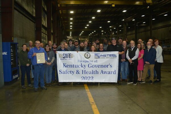 PRESTIGIOUS AWARD PRESENTED – Insteel Wire of Hickman was presented the Kentucky Governor’s Safety and Health Award on April 20 for over 300,000+ hours without a recordable incident at the plant. Lynn Whitehouse, OSHT (Occupational Safety and Health Technology), Acting Directory with the Kentucky Safe at Commonwealth of Kentucky in Frankfort presented the certificate following a brief tour of the plant. Pictured include Plant manager Rob Hitesman, Human Resources/Safety Manager Kristy Owens, Insteel employees, Insteel Corporate office members Director of Safety and Environment Risk Management Phil Kinney, Vice President of Human Resources Steve Burgess, Director of Manufacturing Greg Brown, Senior Vice President and Chief Operating Officer Richard Waggoner, President and CEO H. Woltz, Fulton County Judge/Executive Jim Martin, Fulton County Clerk Naomi Jones, Hickman City Manager David Gallagher, Fulton-Hickman Counties Economic Development Partnership President Mark Welch, Hickman Postmaster Floyd Cash, and media representatives from WCMT Charles Choate, and The Current Barbara Atwill. (Photo by Barbara Atwill)