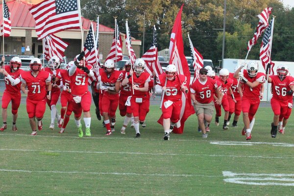 BIG RED, FOR THE RED, WHITE AND BLUE -- South Fulton High School honored Veterans who have served, as well as those currently serving in the Armed Forces during the Sept. 1 football game against Tipton Rosemark. All Veterans received free admission to the game and were recognized during halftime, as well as honored by the SFHS Red Devils football team, with a presentation of colors. (Photos by Jackson Doss.)