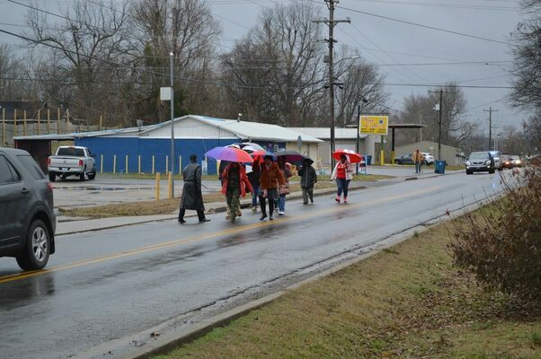 SINGING IN THE RAIN - Members of the "March" paraded down South Seventh Street in Hickman and sang songs in honor of Dr. Martin Luther King, Jr., on Jan. 16, in Hickman. (Photo by Barbara Atwill)