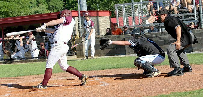 BASE HIT – Carlisle County’s Gavin Jones swings at a pitch, while Fulton County catcher Myles Amberg waits to receive the baseball. The Comets took an early lead, and eliminated the Pilots 18-1 in the opening round of the First District Tournament game played in Clinton. (Photo by Charles Choate)