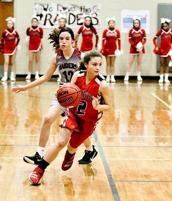 LADY RED DEVIL ON THE RUN – South Fulton Middle School’s Aubree Gore outruns and outguns a sectional tournament opponent, with a win assuring her team of a state tournament appearance this Friday. (Photo by Jake Clapper)