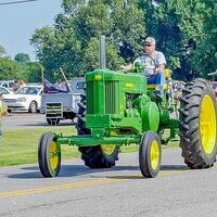 Johnny Hobbs rode his John Deere tractor in the Columbus Homecoming parade.