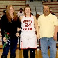 SFHS SENIOR NIGHT RECOGNITION – Erin McDaniel, center, who is a member of the 2018-2019 South Fulton Lady Red Devils basketball team, was honored along with her parents during the school’s recent Senior Night Recognition ceremony. (Photo by Jake Clapper.)