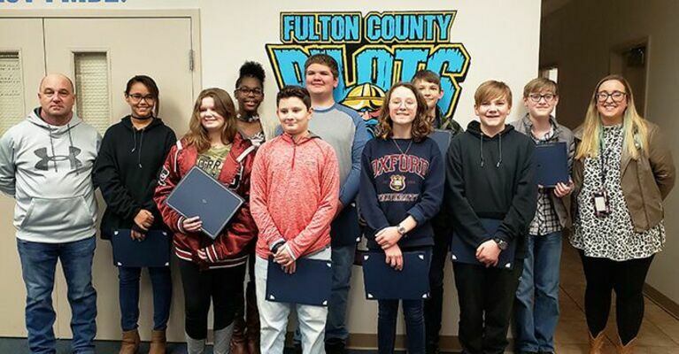 STUDENT RECOGNITIONS – Fulton County Board of Education recognized Fulton County Middle School students for their recent accomplishments in the 2020 District Governor’s Cup, 2020 Future Problem Solving, and 2020 Quick Recall, during a Special Called Meeting of the Board. Pictured, with the students, are Board Chairman Rob Garrigan, far left, and Advisor Katie Smith, far right. (Photo by Barbara Atwill)