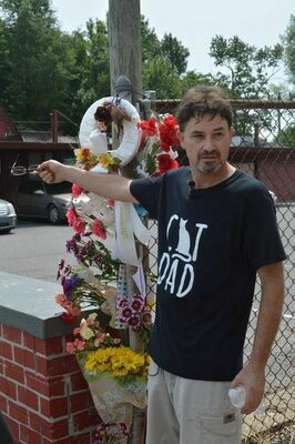 Gary (Bubba) Grooms, Jr. of South Fulton, who is also a Fulton business owner, points toward a make shift memorial Monday, constructed on the site of the discovery of cats which appeared to have been shot. Grooms' family owns the vacant commercial property, where cats have been fed by Grooms and others. Grooms was one of many who addressed the Fulton City Commission Monday night regarding the incident, and is also offering a $5,000 reward for information leading to the prosecution and conviction of those responsible for the killing, as well as those indirectly involved.