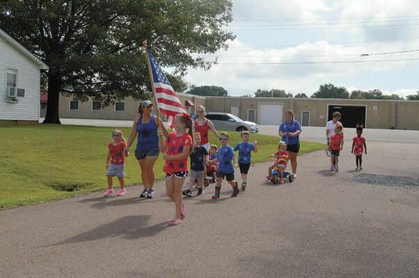 FOR THE RED, WHITE AND BLUE – Children who attend Ms. Angela's Little Angels childcare in South Fulton, display their patriotism in an Independence Day parade through the neighborhood, featured in the Current July 8.