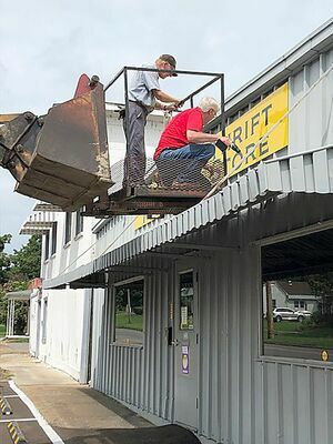 HERE’S THE SIGN – Mounting the sign for the relocated River Town Mission Thrift Store at 1232 Moscow Ave in Hickman are, left to right, Mike Major and Brother Tom Quimby. Quimby has a sign business and made all of the signs, window graphics, customized floor stickers and the sneeze guard at the checkout for the store. Store hours are: Wednesdays 9 a.m. – 3 p.m.; Thursdays from 9 a.m. -4 p.m.; Fridays 9 a.m. – 5 p.m. and first Saturdays of the month 10 a.m. – 2 p.m. (Photos submitted)