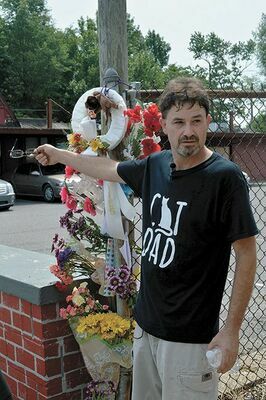 CONCERNS OVER CATS, IN THIS PHOTO PUBLISHED IN THE CURRENT AUG. 14 – Gary (Bubba) Grooms, Jr. of South Fulton, who is also a Fulton business owner, points toward a make shift memorial Monday, constructed on the site of the discovery of cats which appeared to have been shot. Grooms’ family owns the vacant commercial property, where cats have been fed by Grooms and others. Grooms was one of many who addressed the Fulton City Commission Monday night regarding the incident, and is also offering a $5,000 reward for information leading to the prosecution and conviction of those responsible for the killing, as well as those indirectly involved. (Photo by Benita Fuzzell)