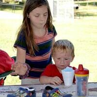 SNOW-CONE TIME – Zoie Pyle and Ryker Henderson shared a snow-cone at the Hickman Pecan Festival, at Jeff Green Memorial Park, Sept. 7. Live music, food vendors, petting zoo, and giant blow-ups were available for everyone to enjoy. (Photo by Barbara Atwill)