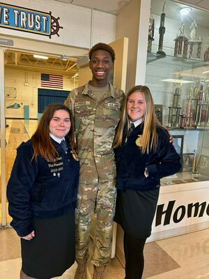 SPECIAL GUEST - Fulton County Future Farmers of America members, Chrislyn Couch and Hannah Murphy are pictured with O.T. Pierce, one of servicemen in attendance for the school sponsored program. (Photo submitted)