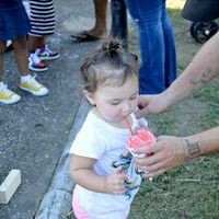 COOL DOWN TIME – Housing Authority of Hickman attended the 26th Annual Hickman Pecan Festival Kid’s Day in the park Sept. 5, and handed out snow-cones. This little lady enjoys a sip during the activities at Jeff Green Memorial Park. (Photo by Barbara Atwill)