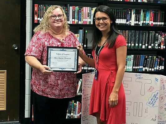 Cayce Batts, the Fulton Independent School’s district Social Worker, right, presented Kathy Thweatt, left,  as Teacher of the month for the Summer Session during the Fulton Independent Board of Education meeting July 20. (Photo by Benita Fuzzell)