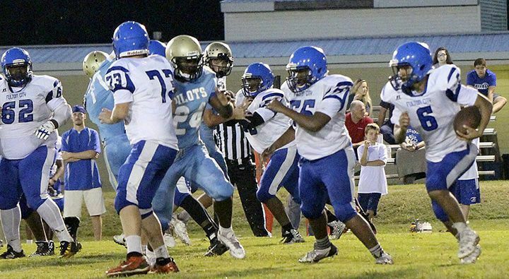 BULLDOG RUN – Fulton City’s Jordan Lannom (6) follows the blocks of Robert McElrath (55) and Blake Nicholas (73), during the third quarter of their game at Fulton County. The Bulldogs had a hard time generating any offense against the Pilots defense, and fell 70-0. (Photo by Charles Choate)